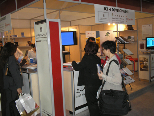Attendees visit Abu-Ghazaleh WSIS booth