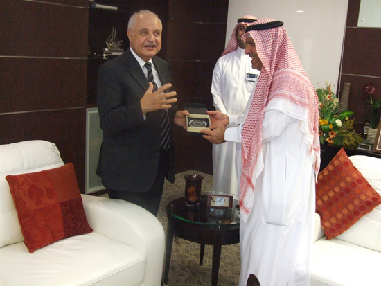 Dr. Issa Alansari presents the shield of the